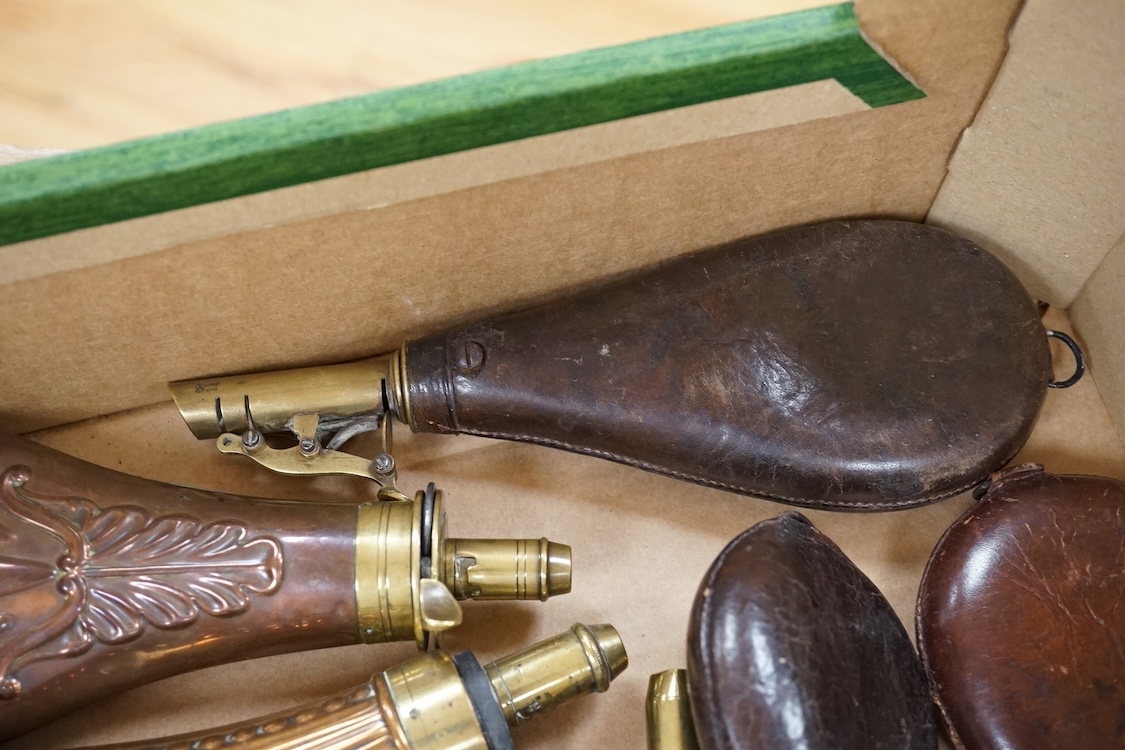 Nine powder flasks and shot flasks, all 19th century, comprising of two horn flasks, one flattened with brass mounts, three shot bags with sprung brass chargers, three copper gun flasks and another of zinc